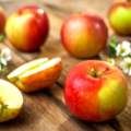 Raw organic apples on wooden background